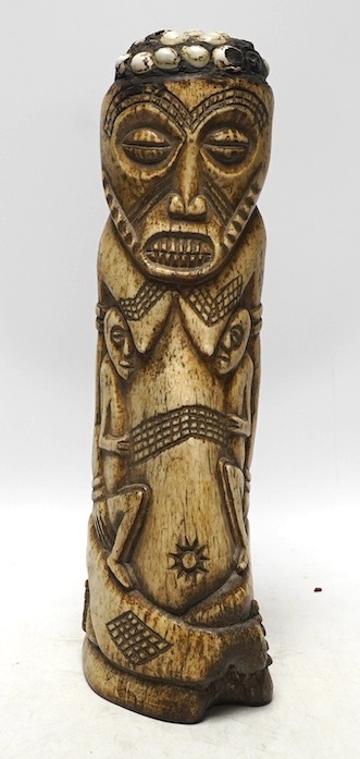 A West African carved animal bone fertility figure, 34cm. Condition - fair